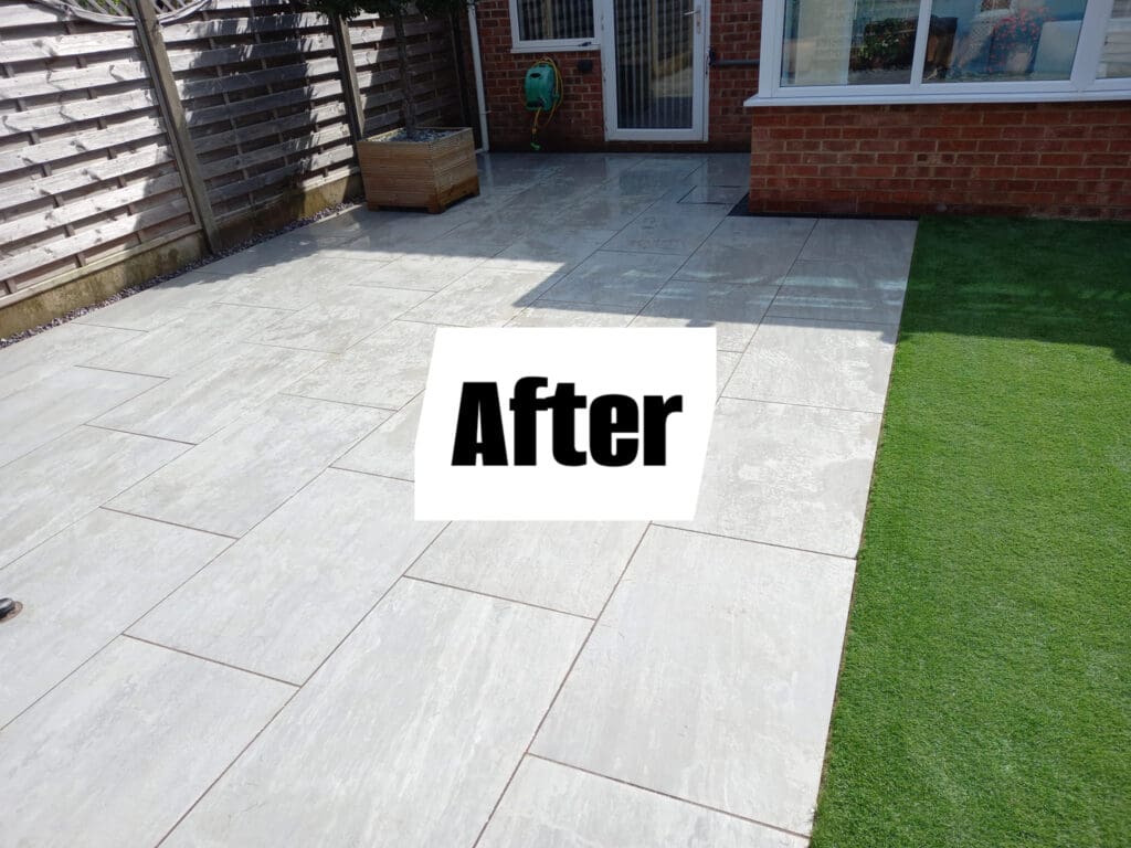 A patio with light gray tiles and a section of artificial grass. A border of wooden fencing and a potted plant are visible. A hose is mounted on the wall of a brick house in the background. The word "After" is displayed on the image.